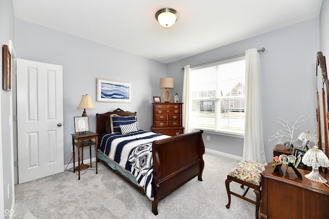 bedroom featuring light carpet