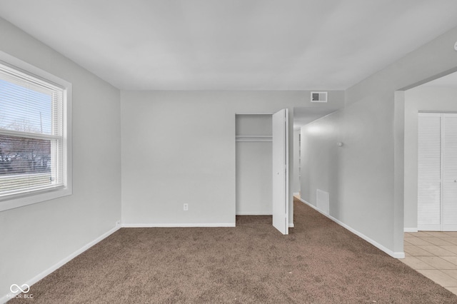 unfurnished bedroom with a closet and carpet