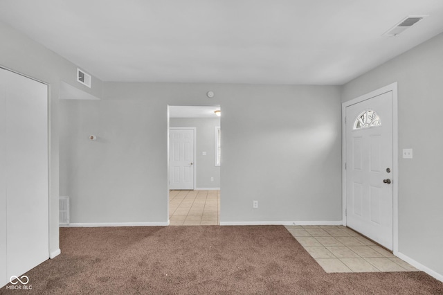 foyer entrance with light carpet