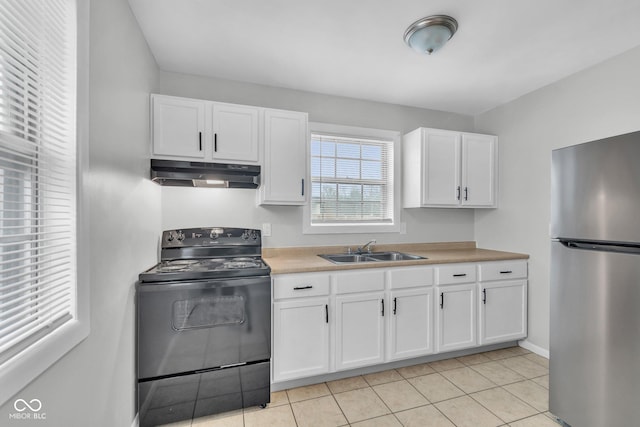 kitchen featuring stainless steel refrigerator, white cabinetry, black range with electric stovetop, and sink