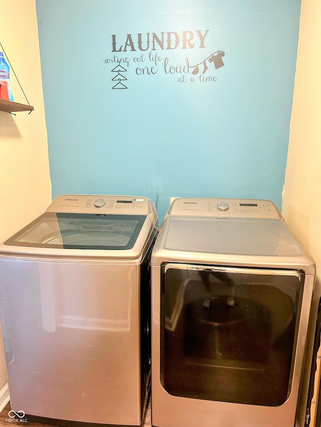 clothes washing area featuring laundry area and washing machine and dryer