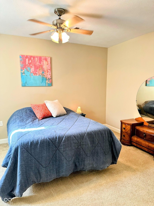 bedroom with carpet flooring, ceiling fan, and baseboards