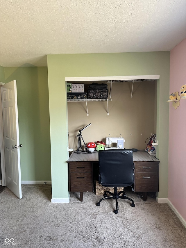 office featuring light carpet, a textured ceiling, and baseboards