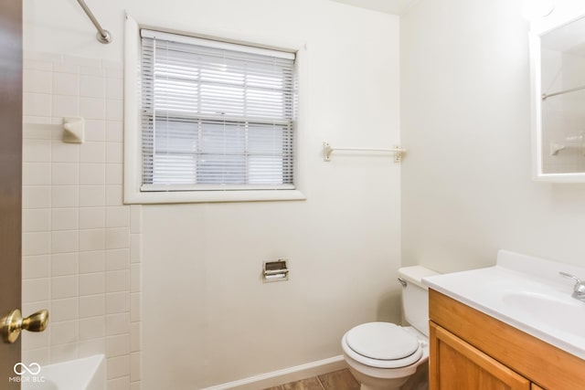 full bathroom with tiled shower / bath combo, vanity, and toilet