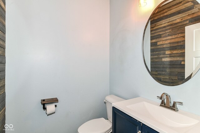1324 Trailside Dr, Greenwood, IN 46143 - bathroom featuring toilet, vanity, and wooden walls