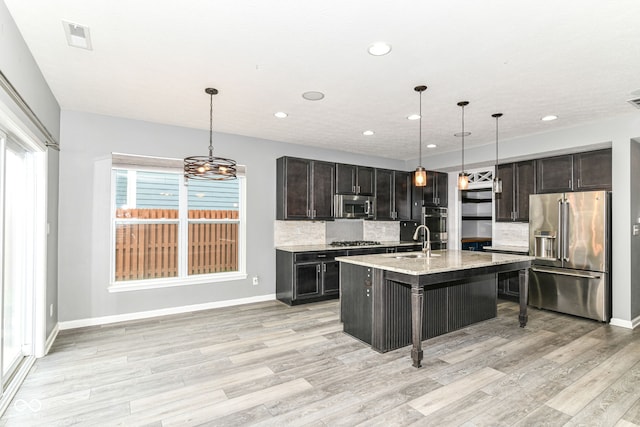 1324 Trailside Dr, Greenwood, IN 46143 - kitchen with appliances with stainless steel finishes, a sink, recessed lighting, backsplash, and light wood finished floors