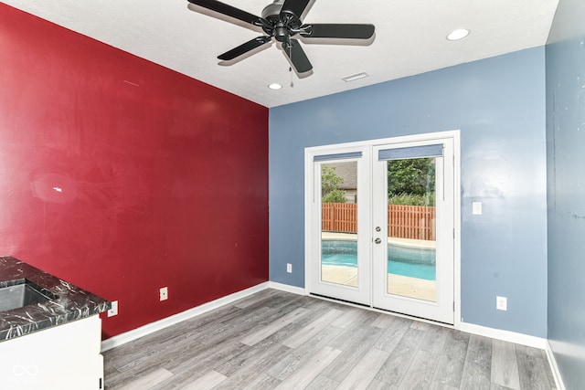1324 Trailside Dr, Greenwood, IN 46143 - unfurnished room with french doors, wood finished floors, baseboards, recessed lighting, and ceiling fan