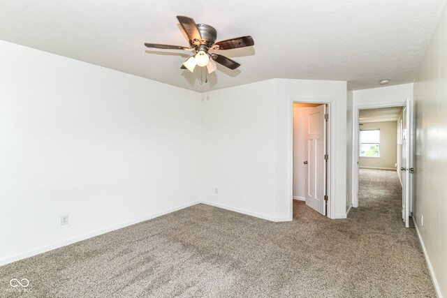 1324 Trailside Dr, Greenwood, IN 46143 - unfurnished bedroom with carpet floors, baseboards, ceiling fan, and a walk in closet
