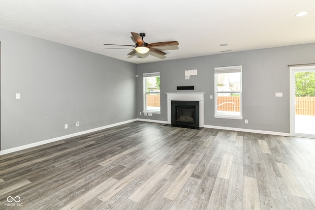 1324 Trailside Dr, Greenwood, IN 46143 - unfurnished living room featuring ceiling fan, a fireplace with flush hearth, wood finished floors, baseboards, and recessed lighting
