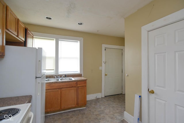 kitchen featuring sink and white fridge