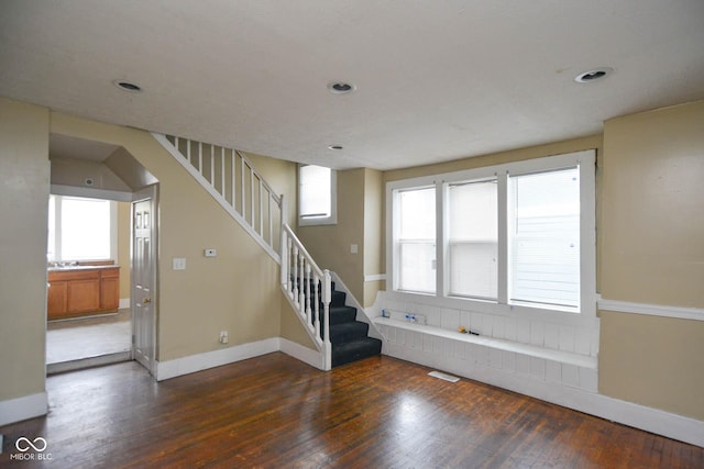 staircase featuring wood-type flooring and a wealth of natural light