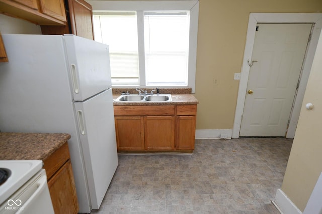 kitchen featuring white refrigerator and sink