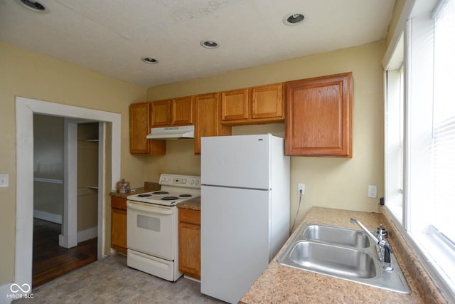 kitchen featuring sink and white appliances