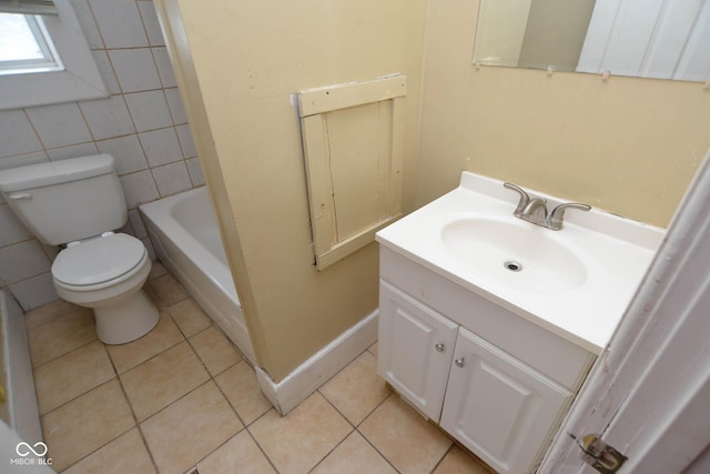 bathroom with vanity, tile patterned flooring, tile walls, and toilet