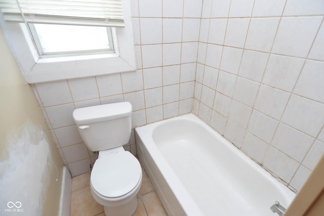 bathroom featuring toilet, tile walls, and a tub