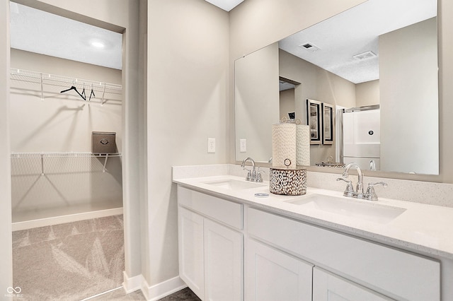 bathroom featuring vanity and an enclosed shower