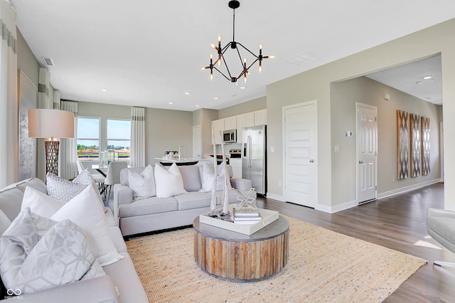 living room featuring hardwood / wood-style flooring and a notable chandelier