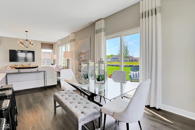 dining area with an inviting chandelier, dark wood-type flooring, and a healthy amount of sunlight