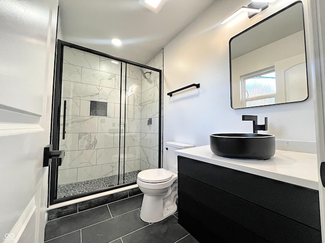 bathroom featuring a stall shower, tile patterned flooring, vanity, and toilet