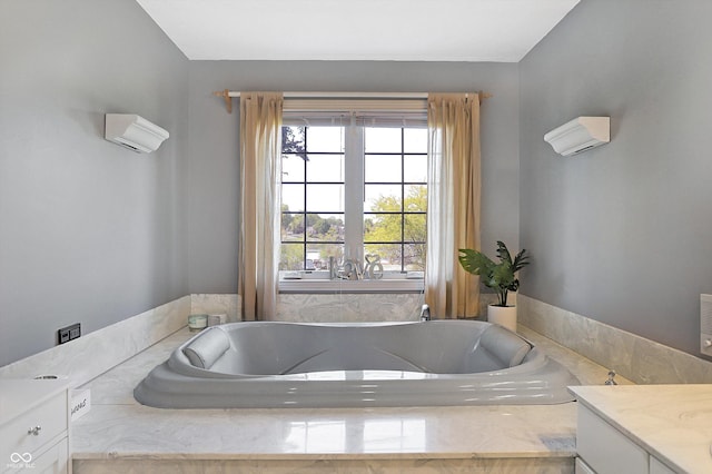 bathroom with vanity, tiled bath, and a wall mounted air conditioner