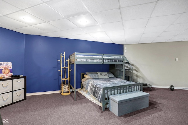 bedroom with carpet flooring and a drop ceiling