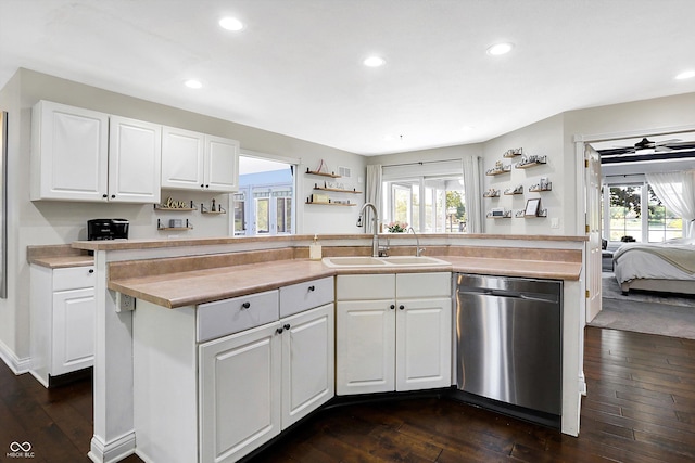 kitchen featuring sink, dark wood-type flooring, white cabinetry, a kitchen island with sink, and stainless steel dishwasher