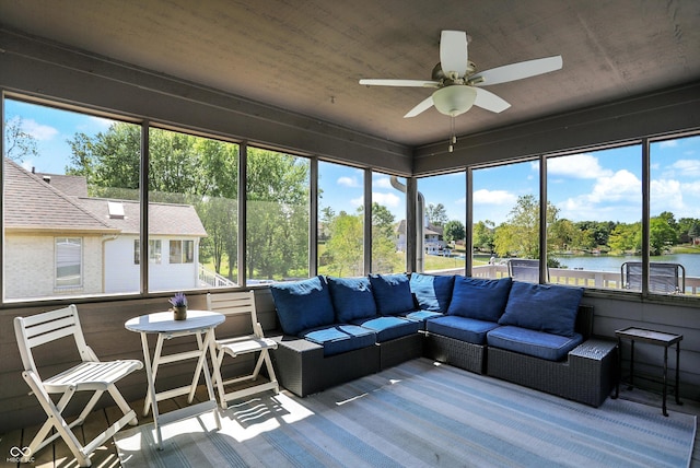 sunroom featuring a water view, a healthy amount of sunlight, and ceiling fan