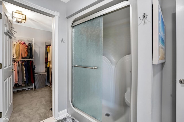 bathroom with a shower with door