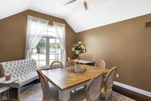 dining area featuring ceiling fan, lofted ceiling, and dark hardwood / wood-style floors