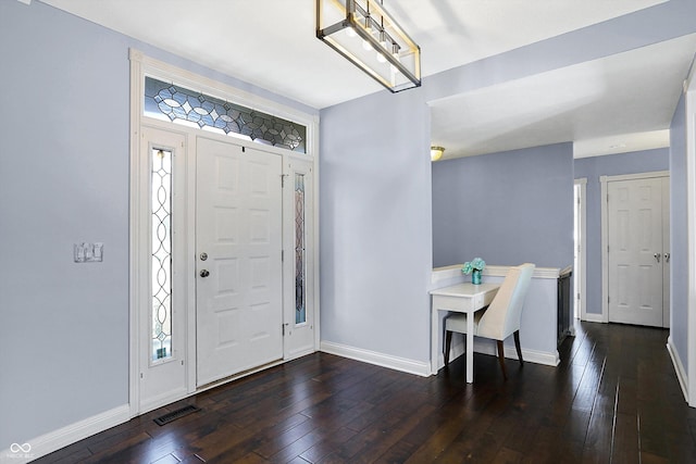 entrance foyer with plenty of natural light and dark hardwood / wood-style flooring