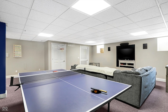 playroom with a paneled ceiling and dark carpet