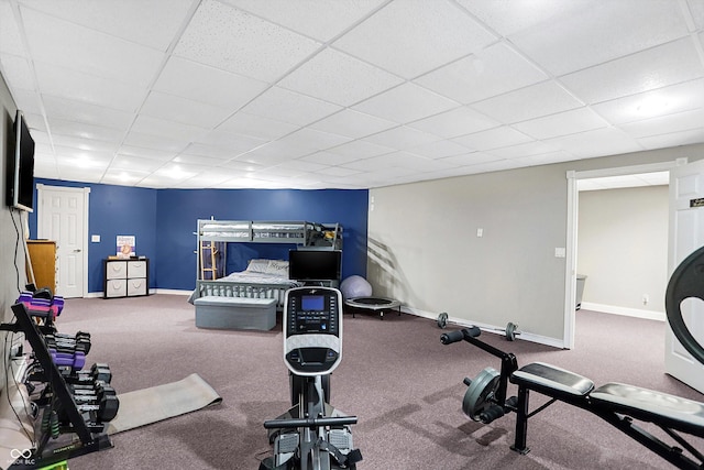 carpeted bedroom with a drop ceiling