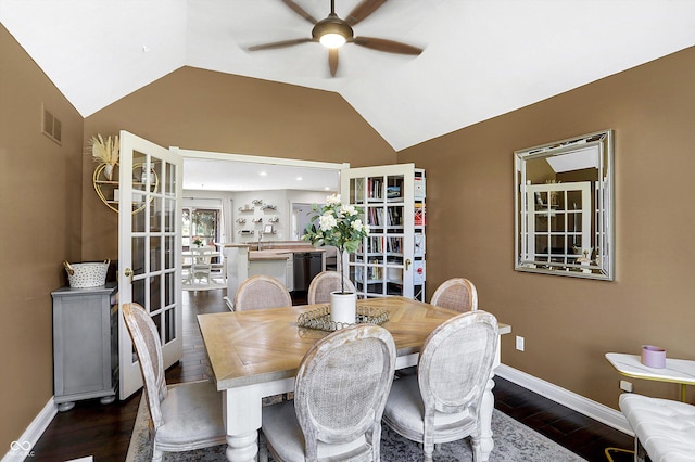 dining room featuring ceiling fan, lofted ceiling, dark hardwood / wood-style flooring, and french doors