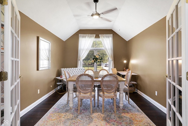 dining space featuring vaulted ceiling, a healthy amount of sunlight, and dark hardwood / wood-style floors