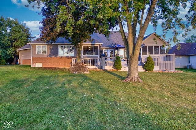 exterior space with a sunroom and a front lawn