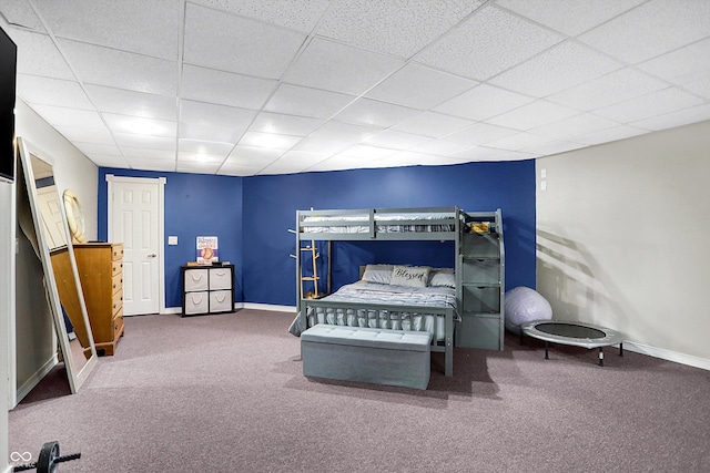 bedroom featuring carpet and a paneled ceiling