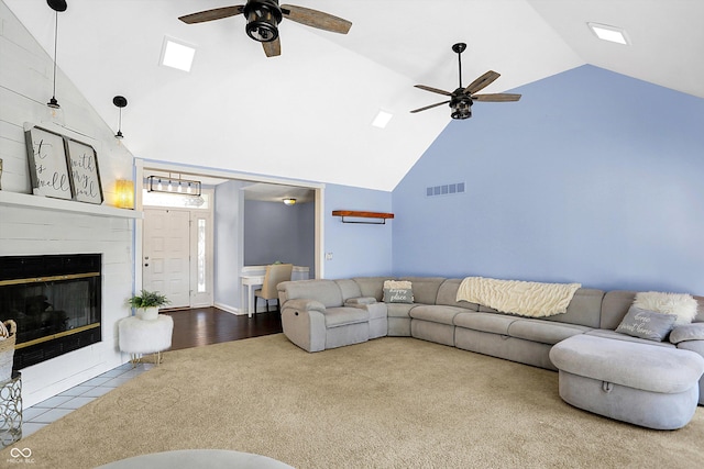 living room with carpet floors, high vaulted ceiling, and ceiling fan