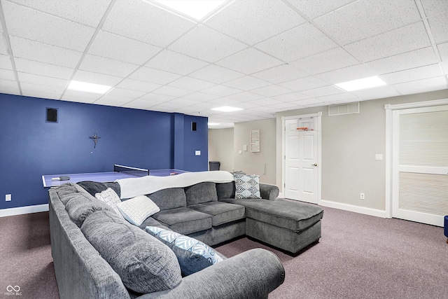 carpeted living room with a paneled ceiling