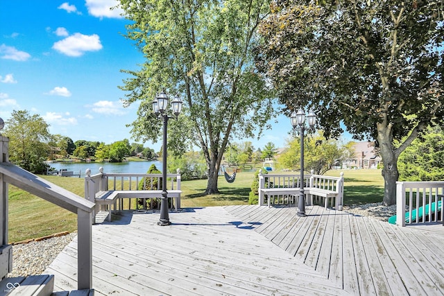 deck featuring a lawn and a water view