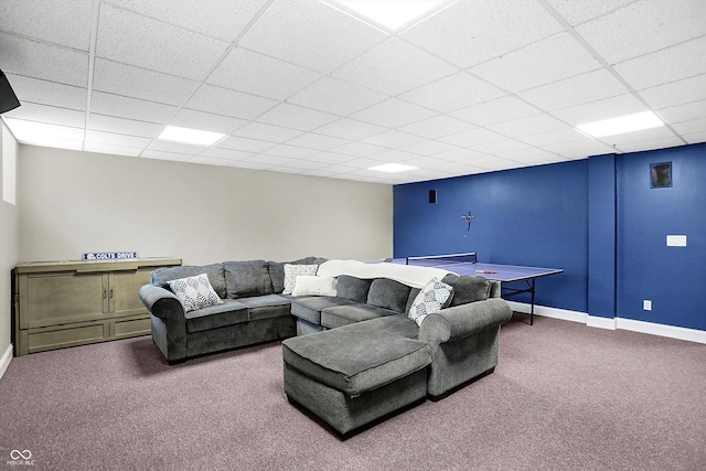 living room featuring carpet flooring and a paneled ceiling