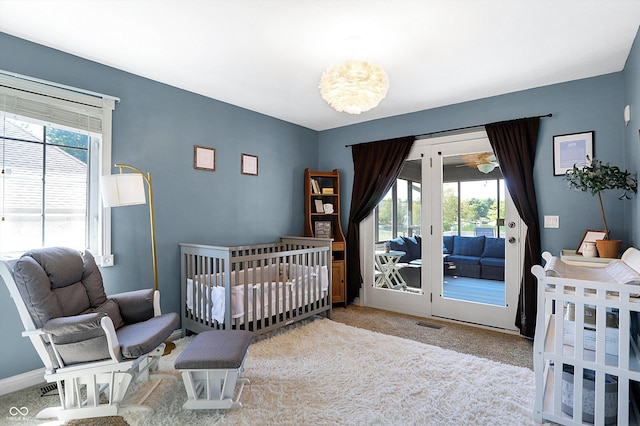 carpeted bedroom featuring access to outside