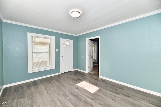 empty room with crown molding and hardwood / wood-style floors