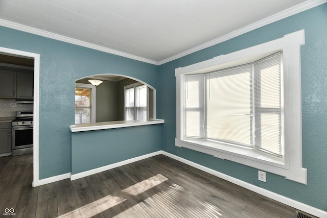 empty room with dark hardwood / wood-style flooring and crown molding