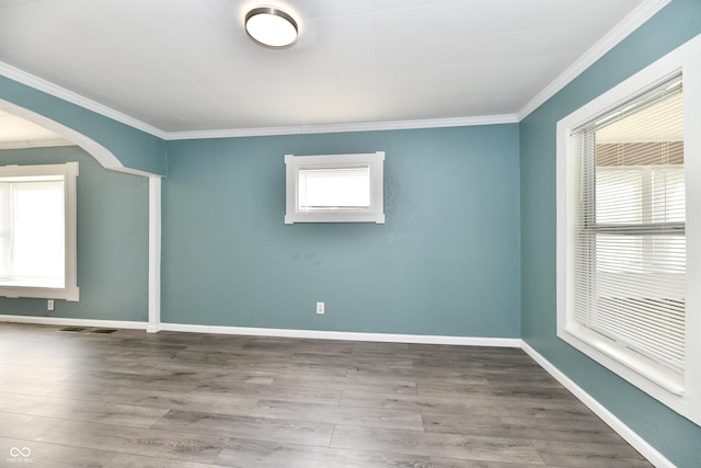 unfurnished room featuring ornamental molding and wood-type flooring