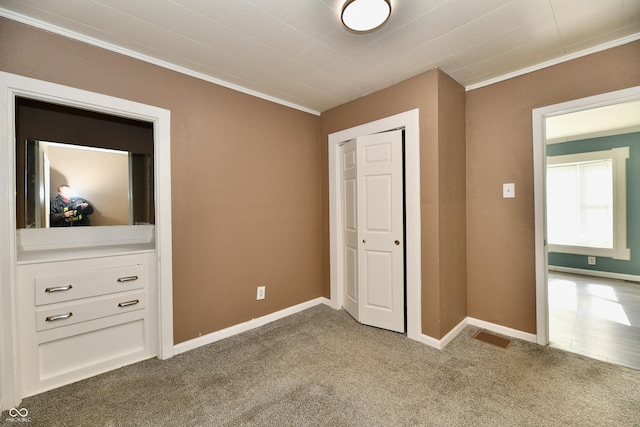 unfurnished bedroom featuring ornamental molding and carpet flooring