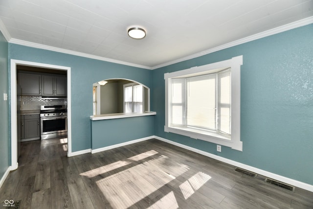 spare room featuring crown molding and dark hardwood / wood-style floors