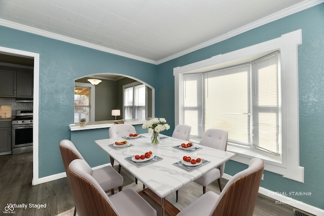 dining area with dark wood-type flooring and ornamental molding