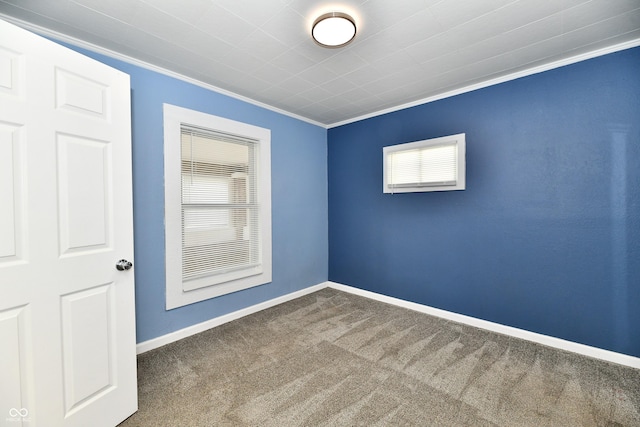 carpeted spare room with crown molding