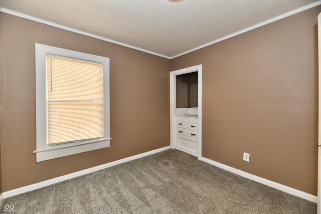 unfurnished room featuring ornamental molding and carpet floors