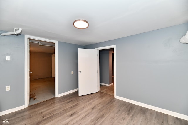 unfurnished bedroom with hardwood / wood-style floors